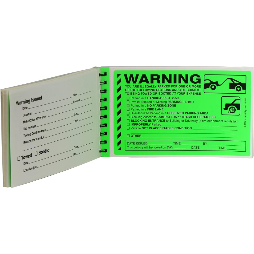 Open booklet of green warning stickers for illegal parking violations. The right page lists multiple infractions with checkboxes (e.g., fire lane, handicapped space, blocking access), and space for date and time. The left page records detailed vehicle and violation information, including towing or booting status.