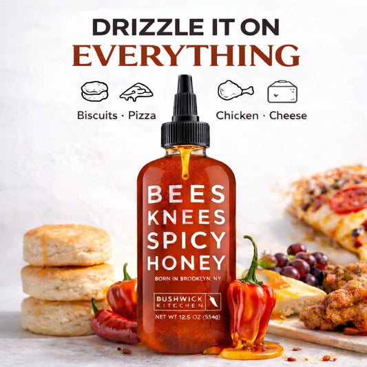 A bottle of Bees Knees spicy honey with food in the background and a headline, 'Drizzle it on everything'
