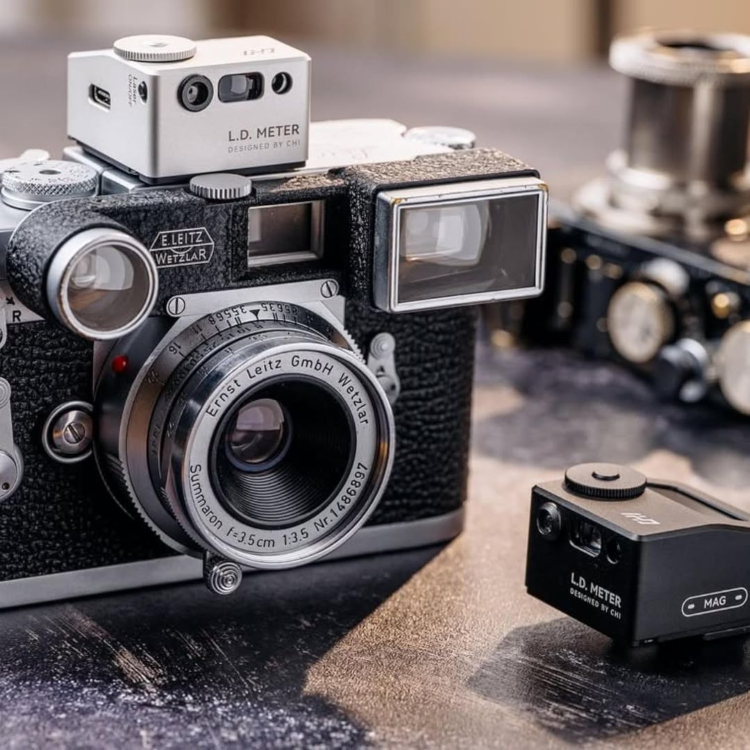CHI L.D. Light Meter Pro mounted on a vintage Leica film camera beside a black light meter accessory