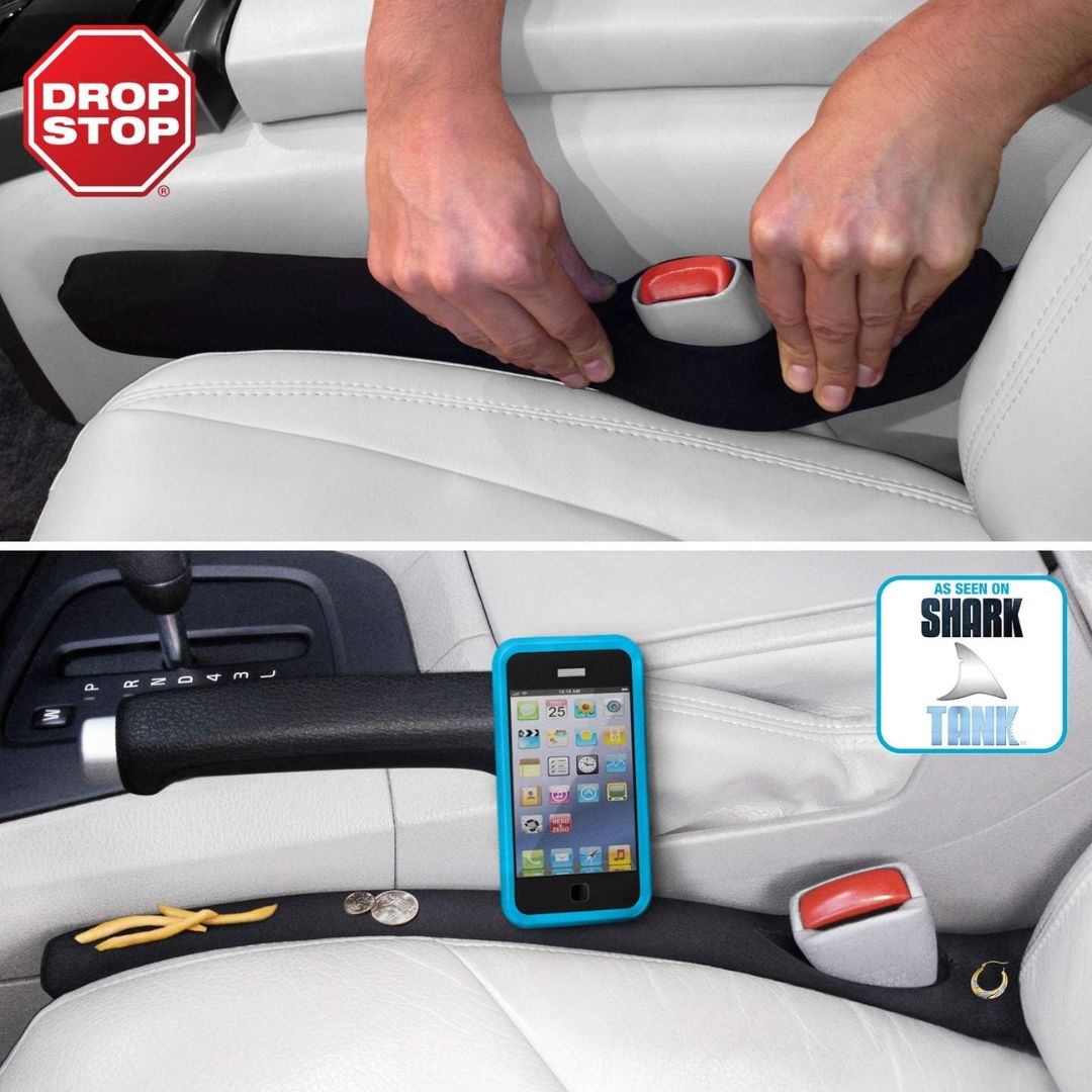 A pair of hands installing a car seat gap filler in a car.