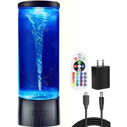 A cylindrical LED water tornado lamp with a swirling blue water vortex, shown with a white remote control, a black wall charger, and a black USB cable on a white background.