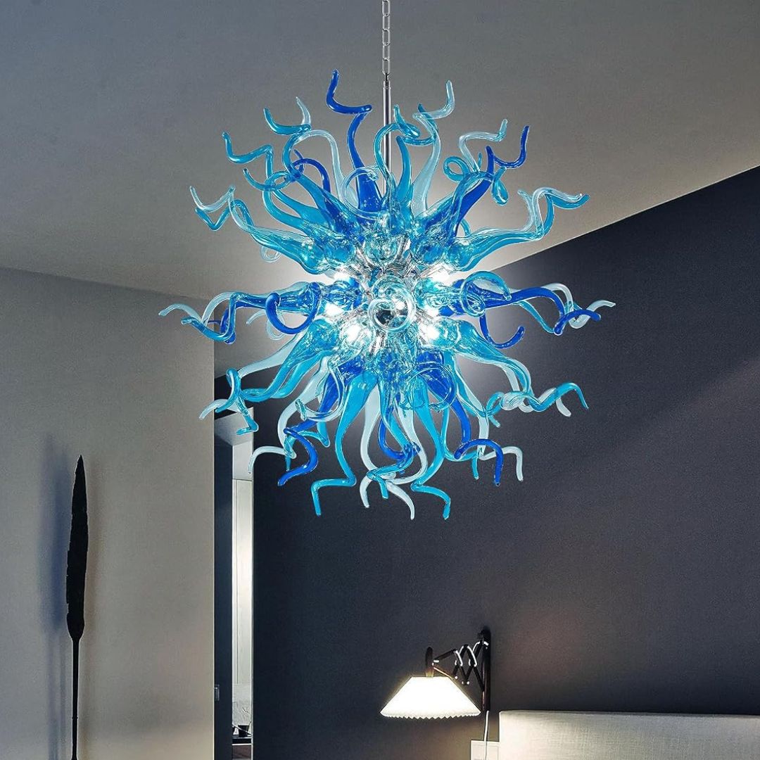 A blue hand blown colorful glass chandelier with a spiral design hanging from a ceiling