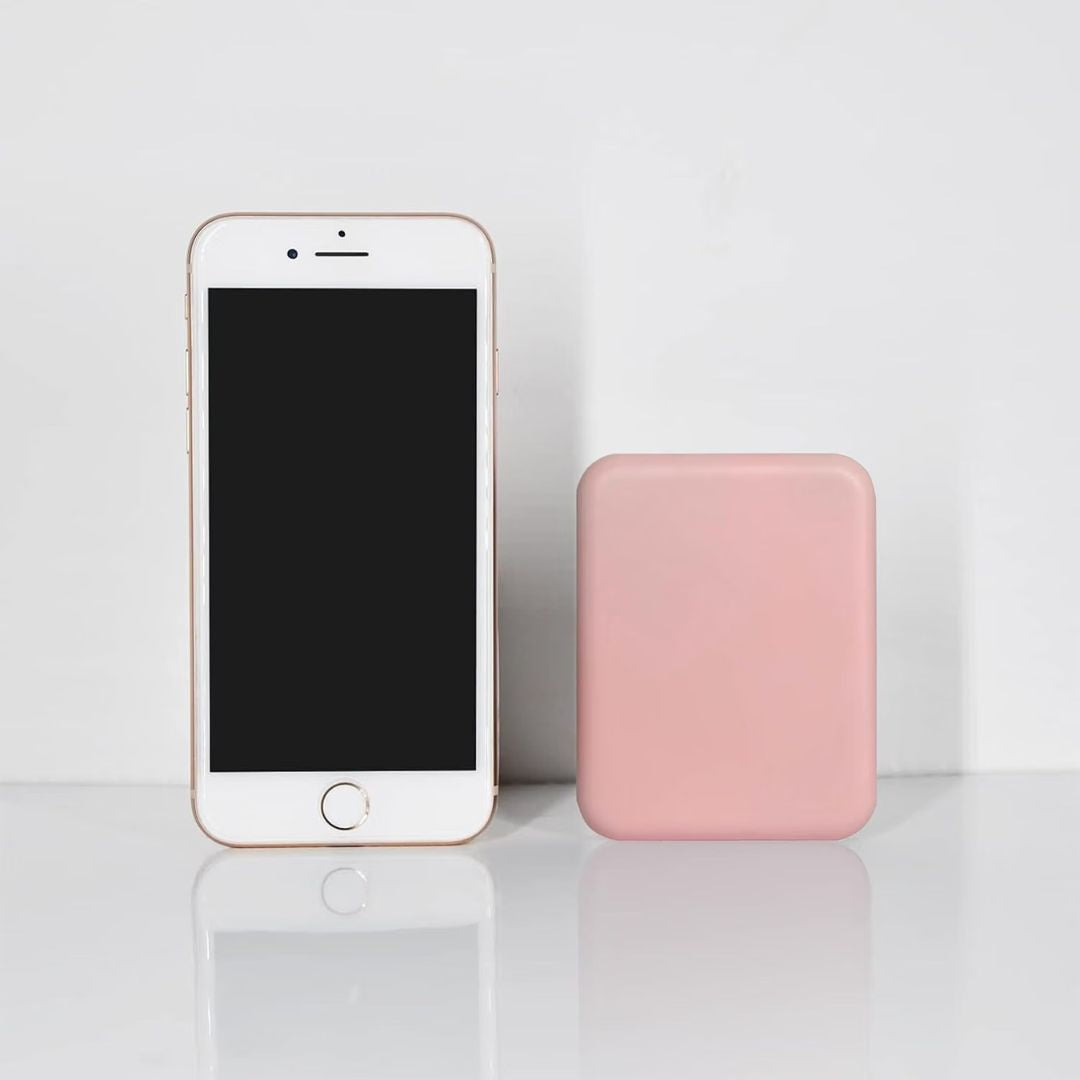 Pink compact mirror shown alongside a cell phone