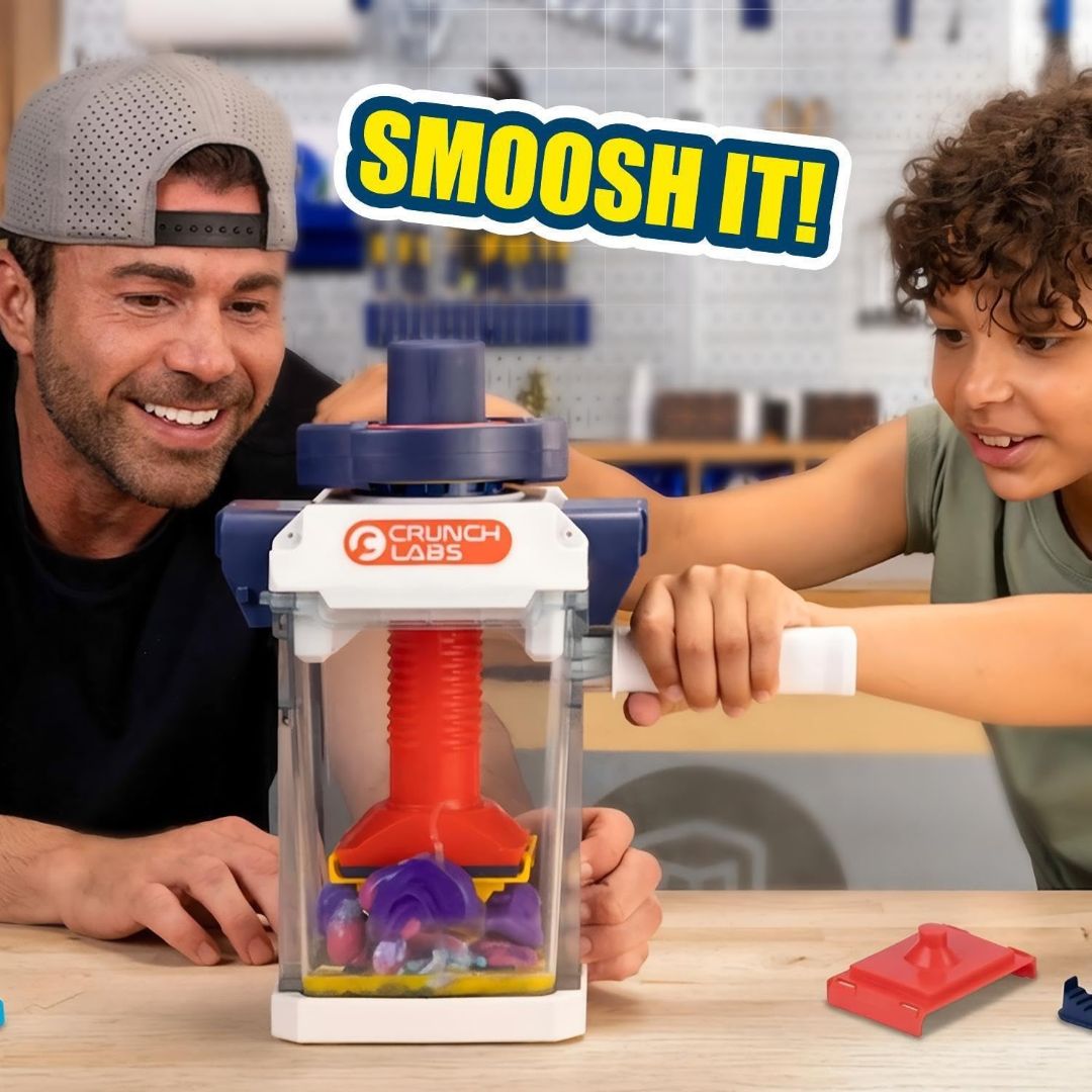 STEM crushing toy being operated by a child to smash and flatten small objects inside the clear chamber