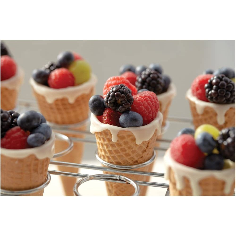 A cupcake cone baking rack filled with ice cream cones with fresh berries in each cone.