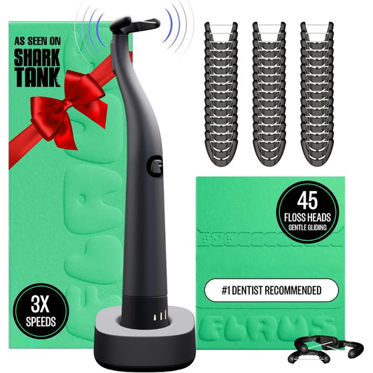 Black dental flosser with packaging and additional floss heads on a white background