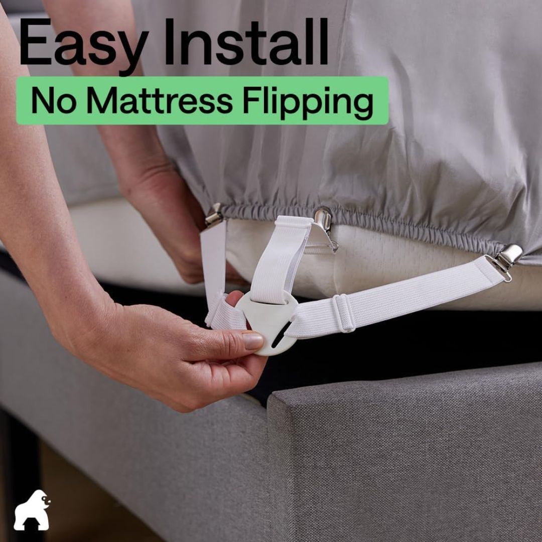 White fitted bed sheet holder clipped to a mattress corner for easy installation without flipping the mattress