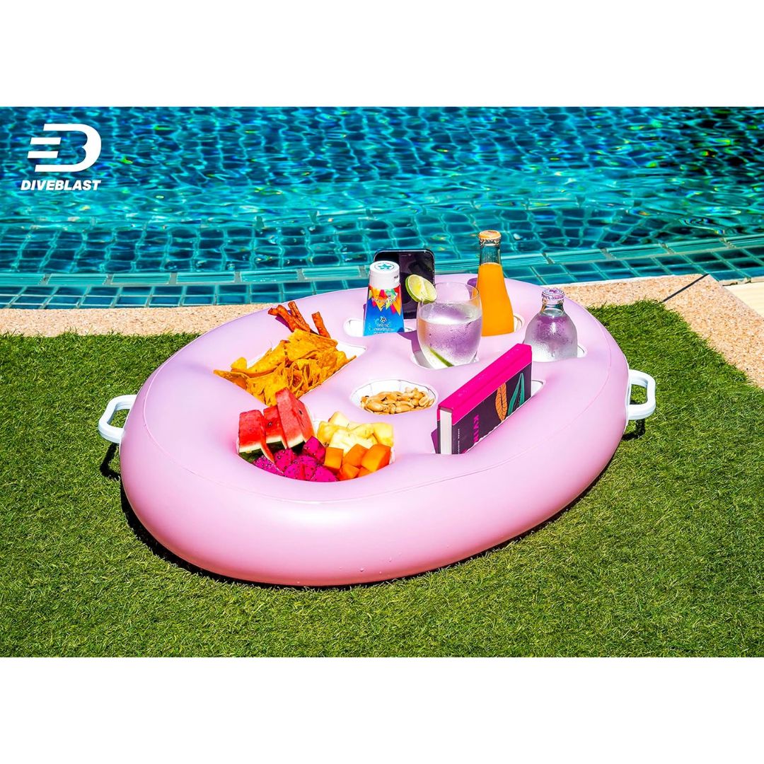 Pink inflatable pool table with snacks and drinks by a pool