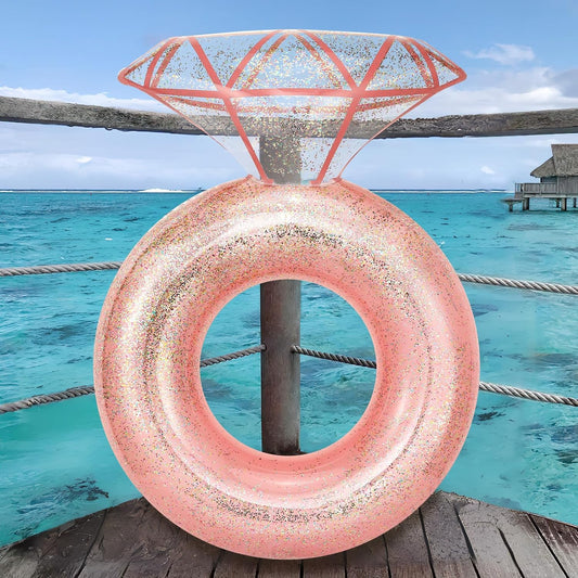 A giant pink inflatable pool float shaped like a diamond ring..