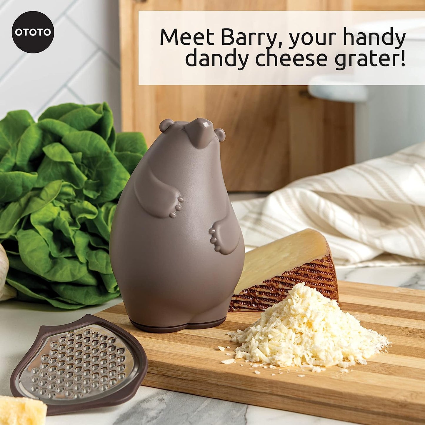 A kitchen grater shaped like a brown bear sits on a chopping board next to grated cheese.