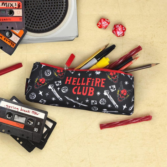 Accessory pouch with 'Hellfire Club' design on a beige surface with stationery items.
