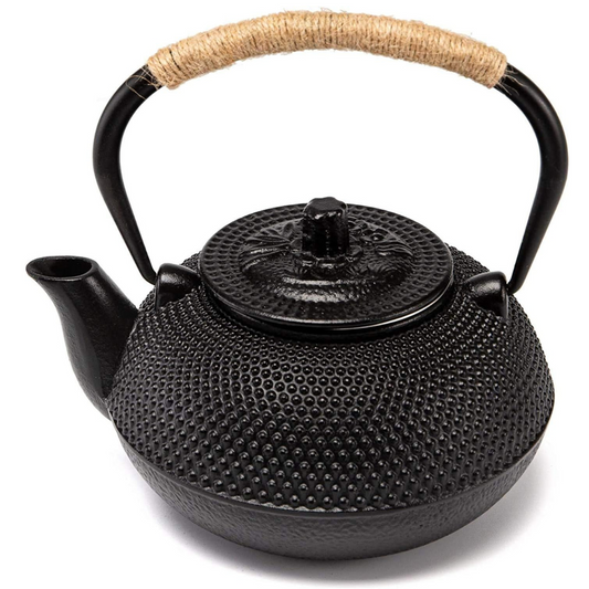 A traditional Japanese tetsubin cast iron teapot with a textured black surface and a woven rattan-wrapped handle.