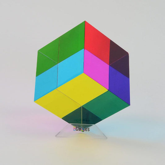 MY Cubes Mega 95mm optical color cube showing overlapping cyan, magenta and yellow panels on a clear display stand