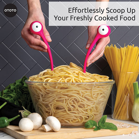 A pair of hands are holding a pair of pasta and salad servers to scoop up spaghetti. The scoopers have eyeballs so it looks like a monster.
