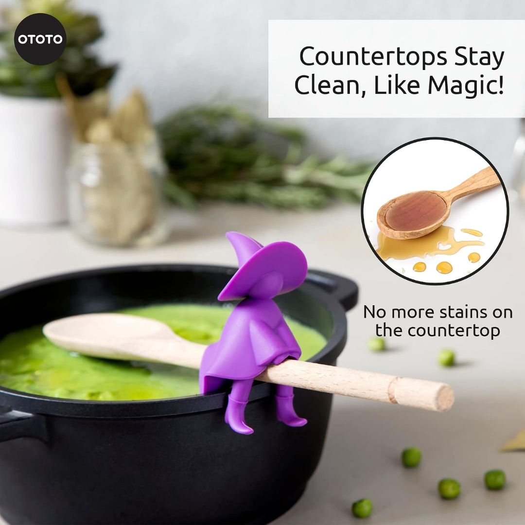 Purple witch shaped kitchen spoon holder and steam releaser in a pot with text about countertop cleanliness.