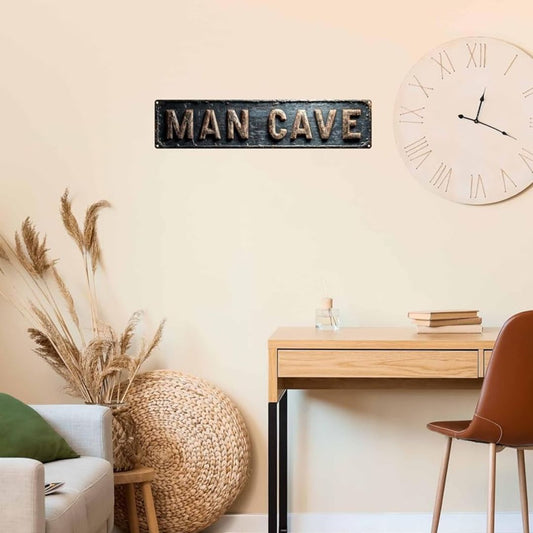 Decorative 'Man Cave' sign above a desk with a clock on a wall.