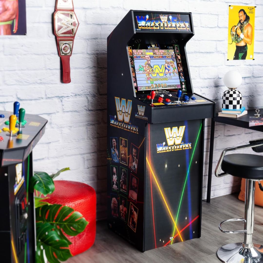 A retro wrestling arcade gaming machine in a room with game themed decorations