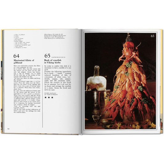 Open Dalí Les dîners de Gala cookbook showing recipes beside a surreal crayfish dish photograph