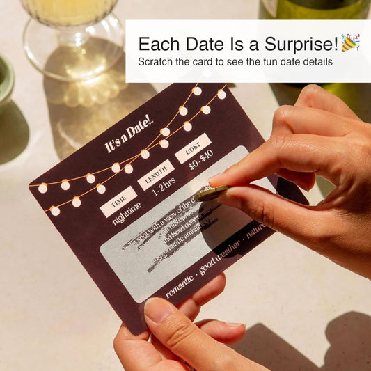 A pair of hands scratching off a mystery date card with text, 'Each Date Is A Surprise, scratch the card to see the fun date details.'