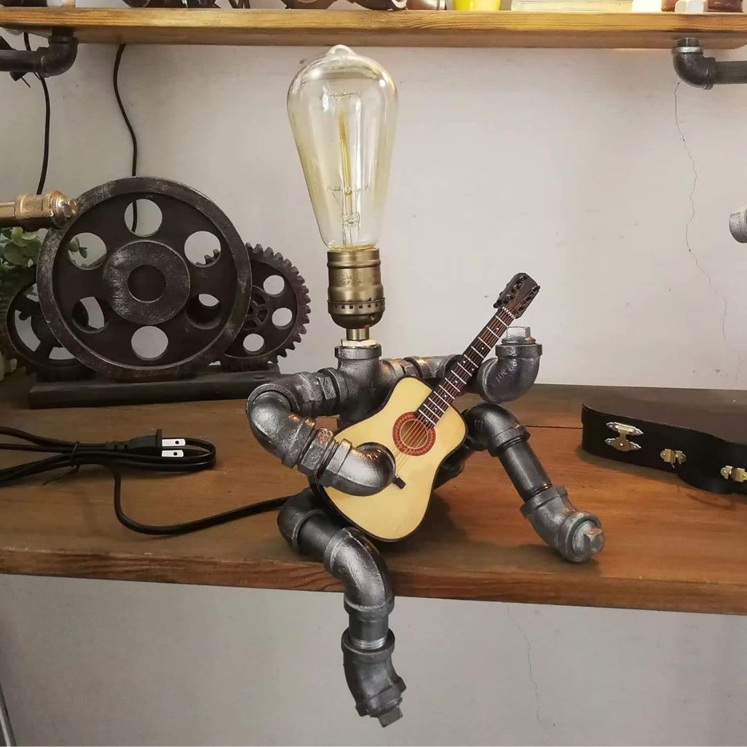 A steampunk lamp holding a guitar on a work bench,.