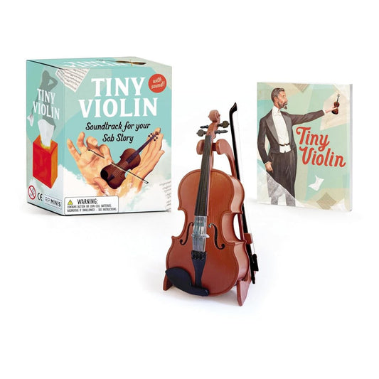 Tiny violin with packaging and book on a white background