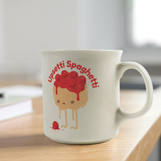 White mug with 'Upsetti Spaghetti' design on a wooden surface