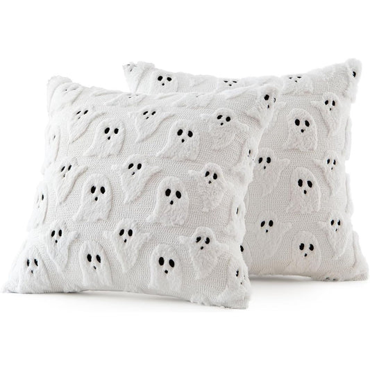 Two white Halloween pillow covers featuring raised fluffy ghost patterns with black eyes and mouths on a white background.