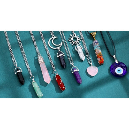 10 crystal pendant necklaces each with a different type of crystal pendant at the end of a silver chain.