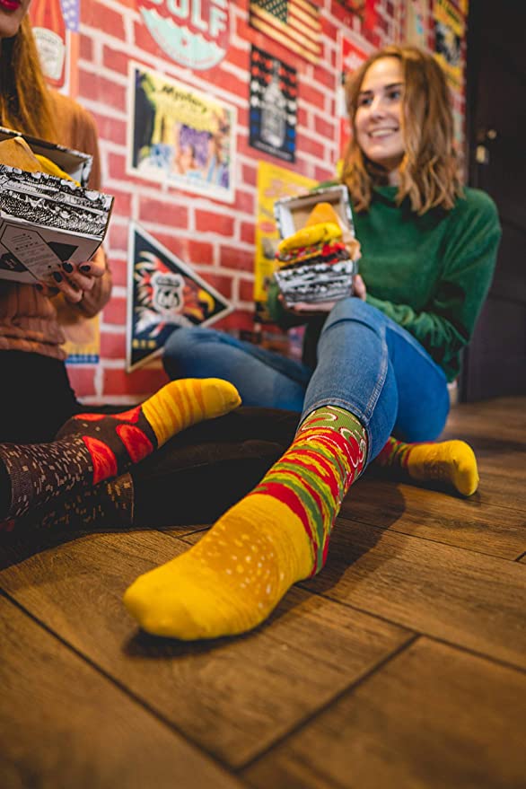 A woman is wearing a pair of burger socks.