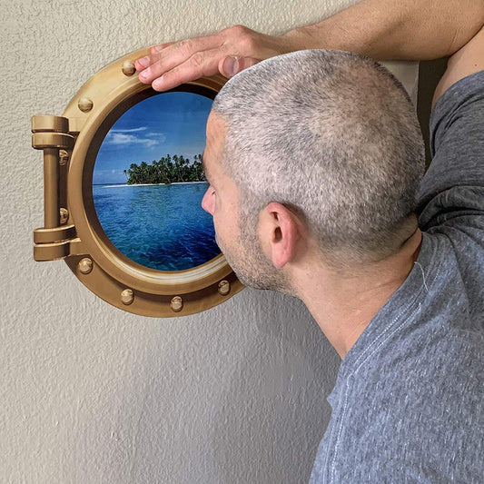 This wall decal makes it look like you have a cruise ship porthole in the room looking out towards a tropical island in the distance.