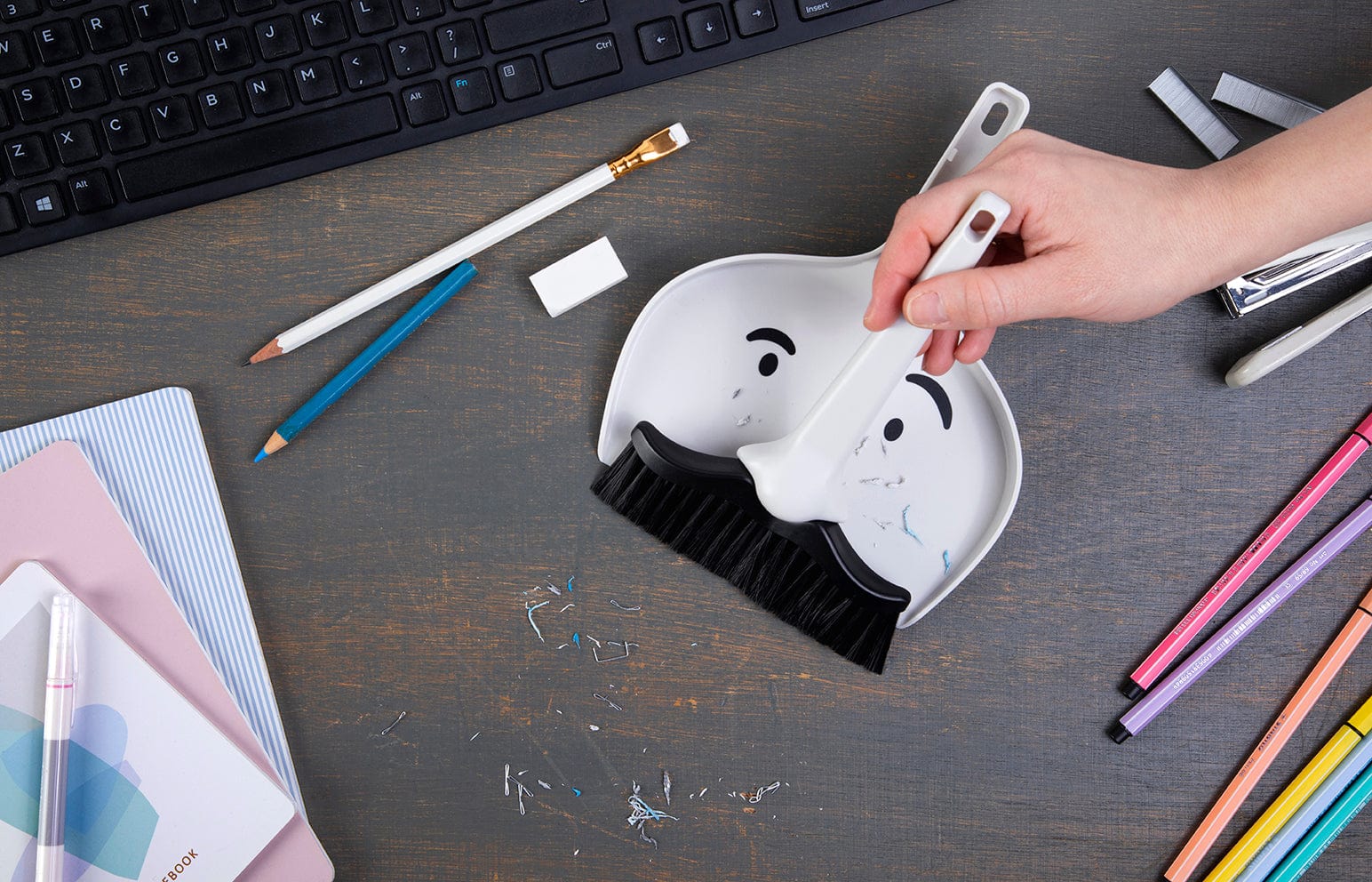 A funny dustpan and broom set being used to clean up a mess