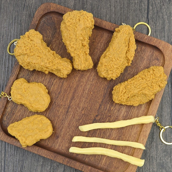 A platter of keychains which look like fried chicken pieces and French fries.