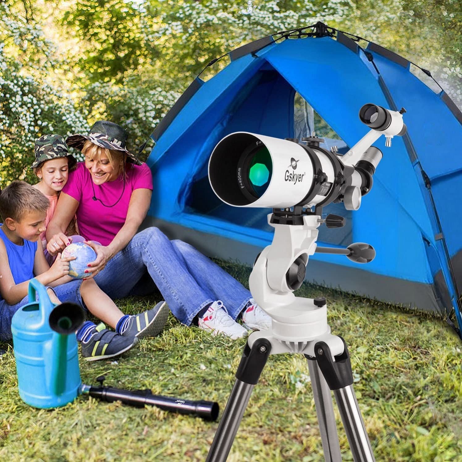 A Gskyer 80mm refractor telescope along with a family outside next to a blue tent.