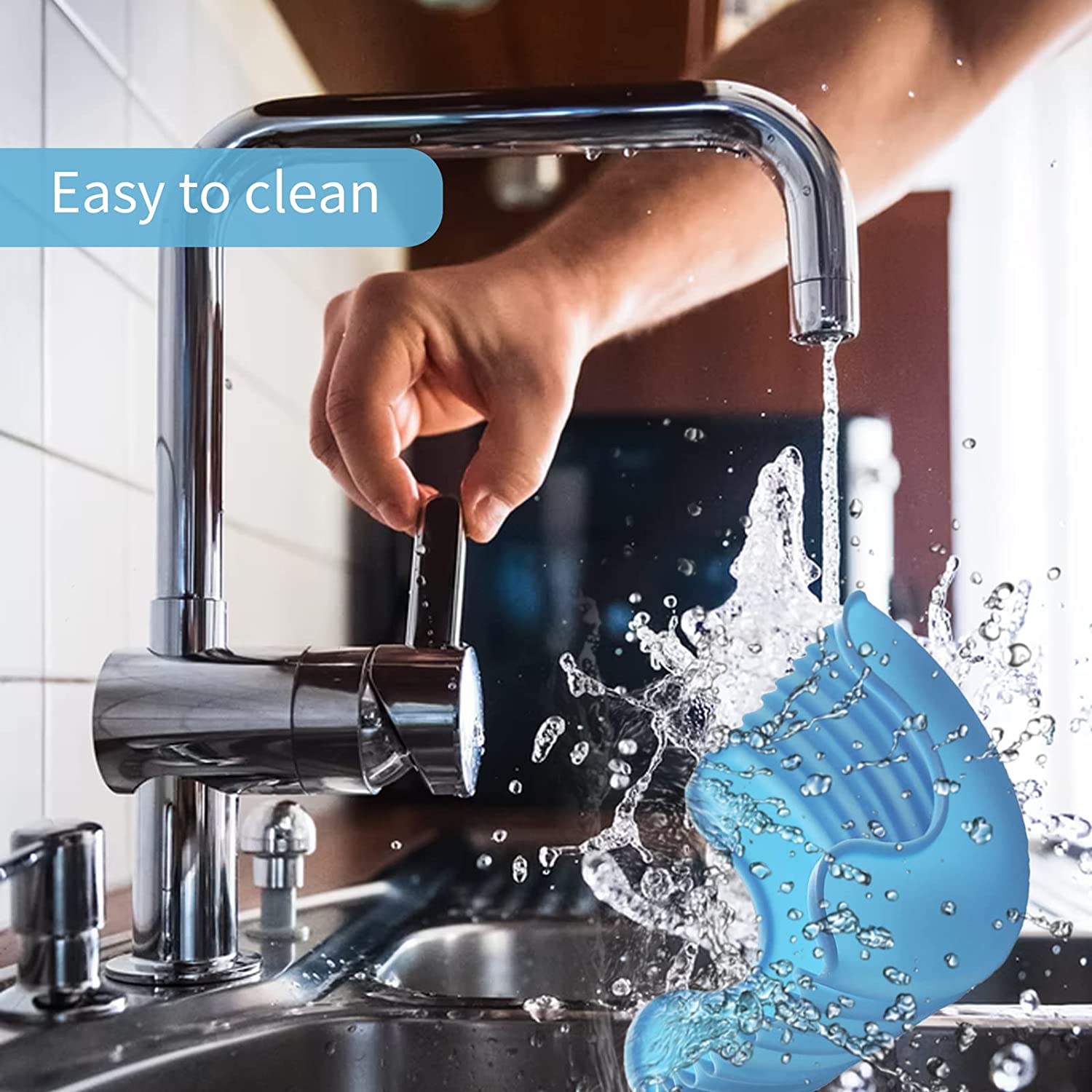 A person's hand showing them washing the hamburger holder which is made of silicone and is washable.