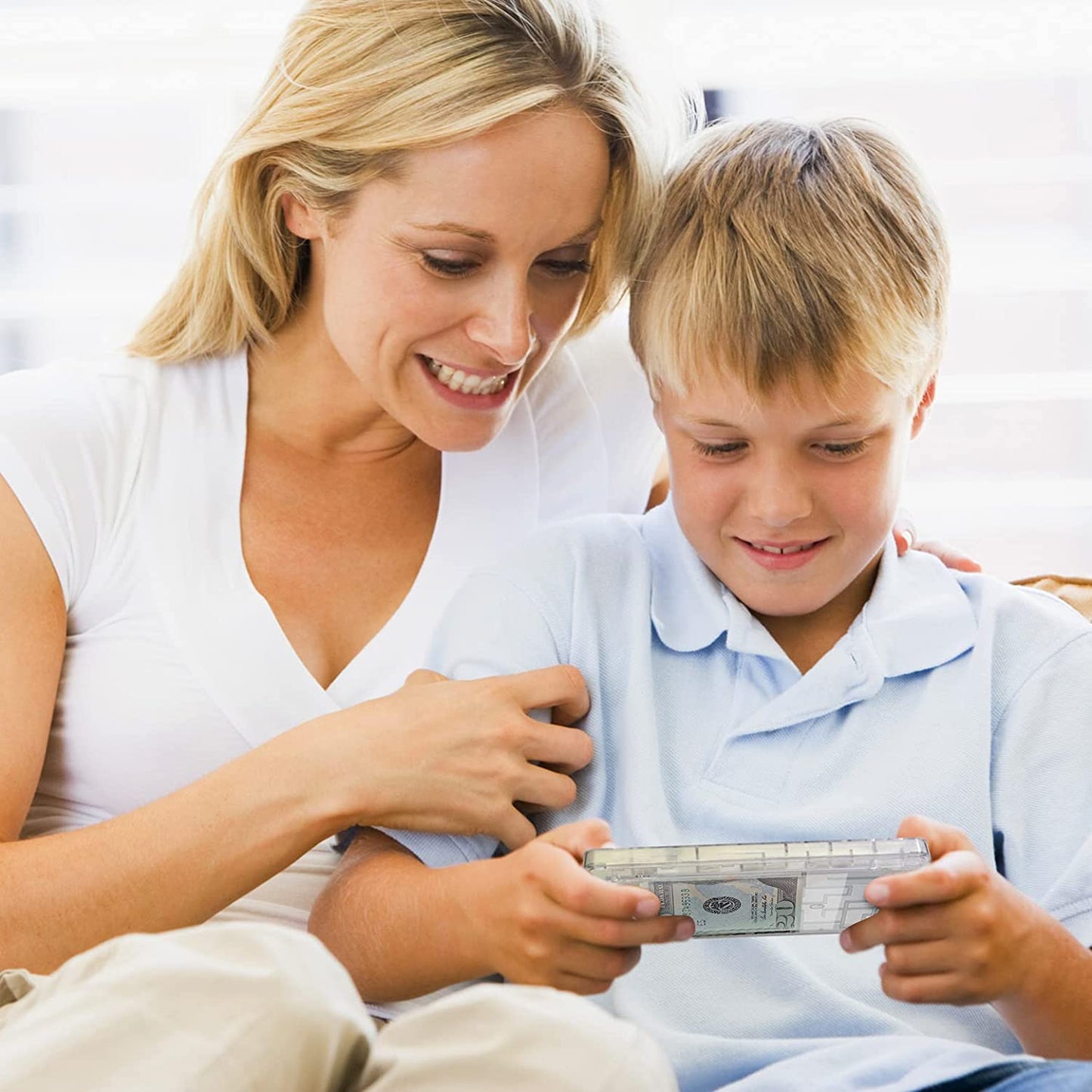 A mother and child are try to solve a money puzzle maze box to get to the cash inside.