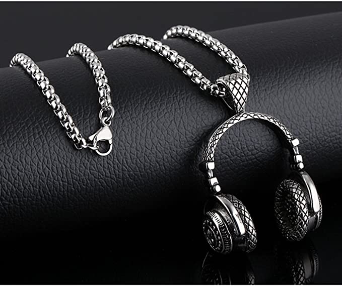 A silver colored pendant and chain with a pair of headphones as a pendant.