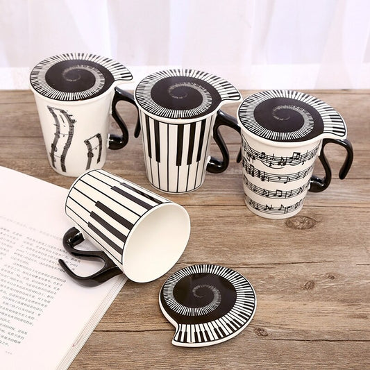 Four mugs with lids which all feature music inspired imagery.