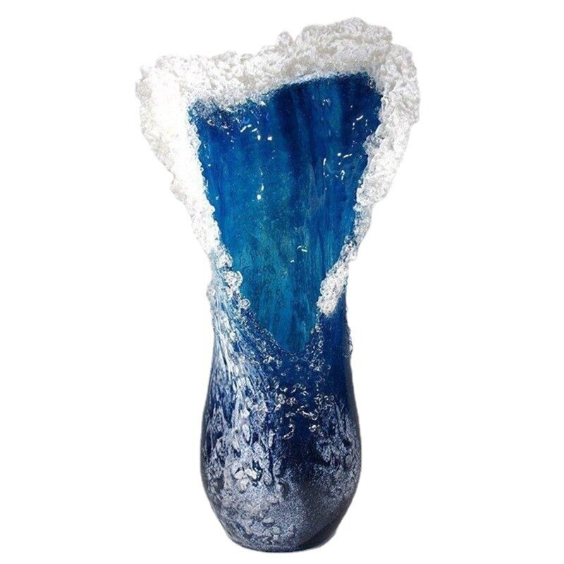 A beautiful blue and white resin vase which looks like an ocean wave in motion.
