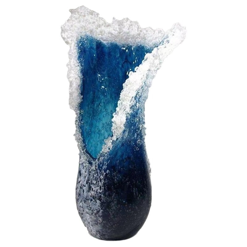 A tall resin vase which looks like an ocean wave frozen in the moment.