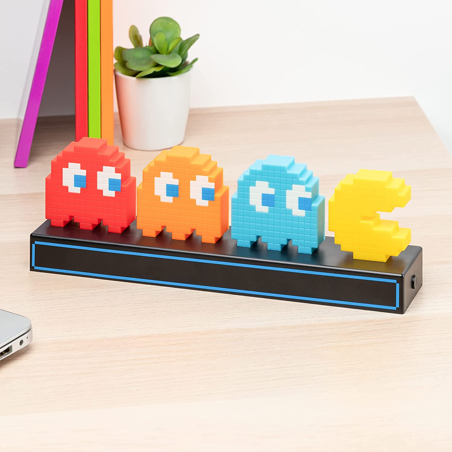A retro 80's light featuring Pac-Man being chased by three ghosts.