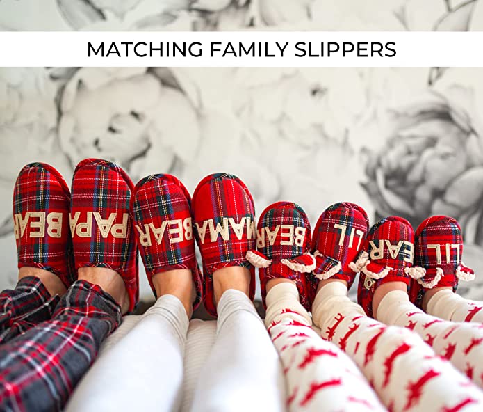 Four pairs of feet wearing red plaid slippers. There are words on each of the slippers which reads, 'Papa Bear, Mama bear, Lil Bear and another Lil Bear.' These are individual slippers for each member of the family.