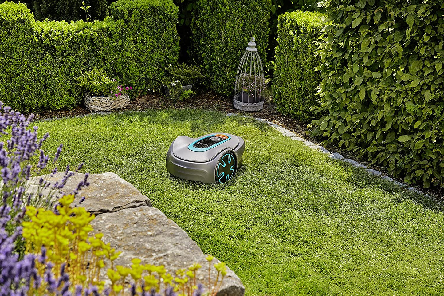 A robotic lawn mover resting on a green lawn.