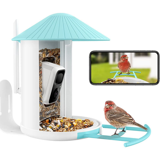 A small brown bird is sitting on a smart bird feeder which has a camera attached to the centre of the feeder. There is also an inset picture of a cellphone showing the captured image from the feeder.