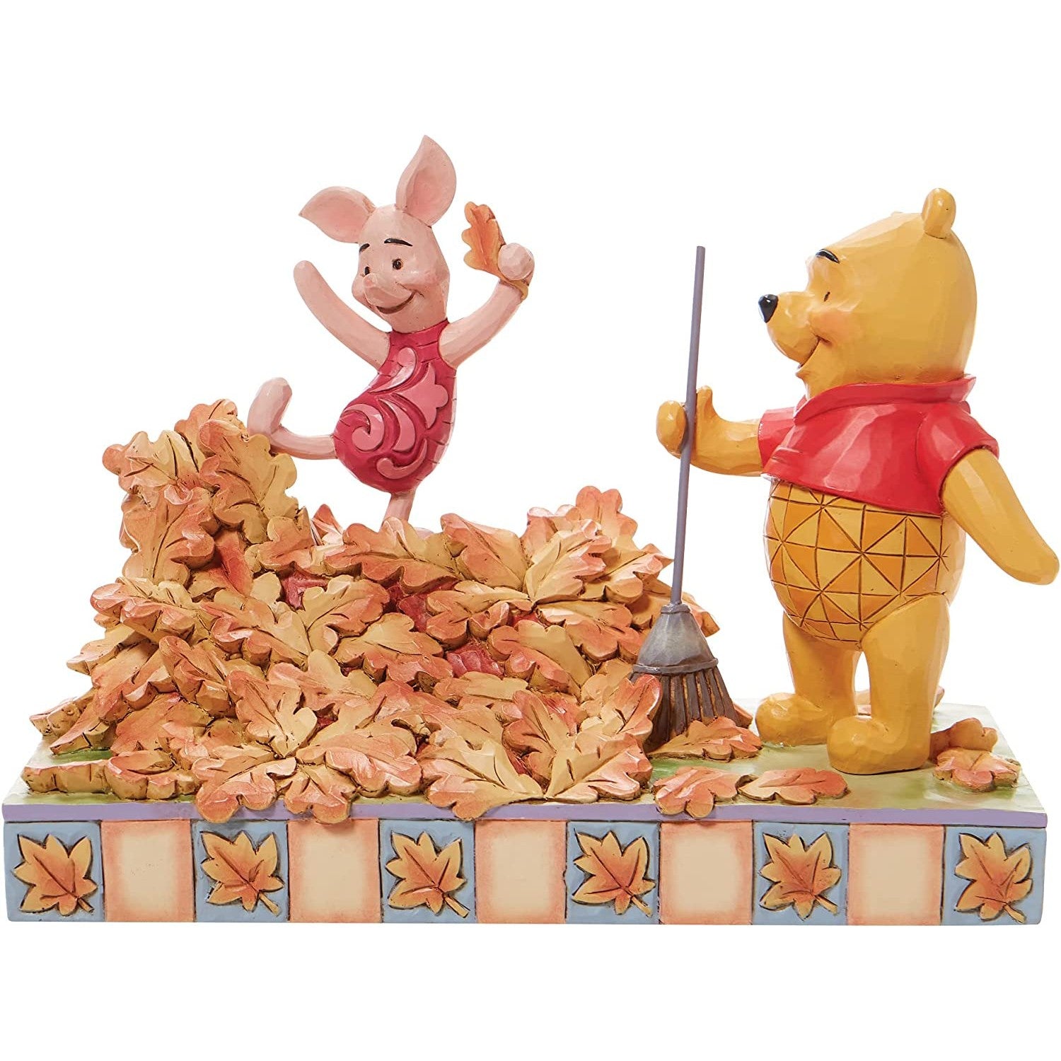 A figurine of Winnie The Pooh and Piglet.