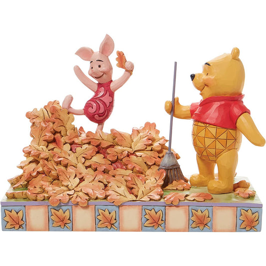 A figurine of Winnie The Pooh and Piglet.