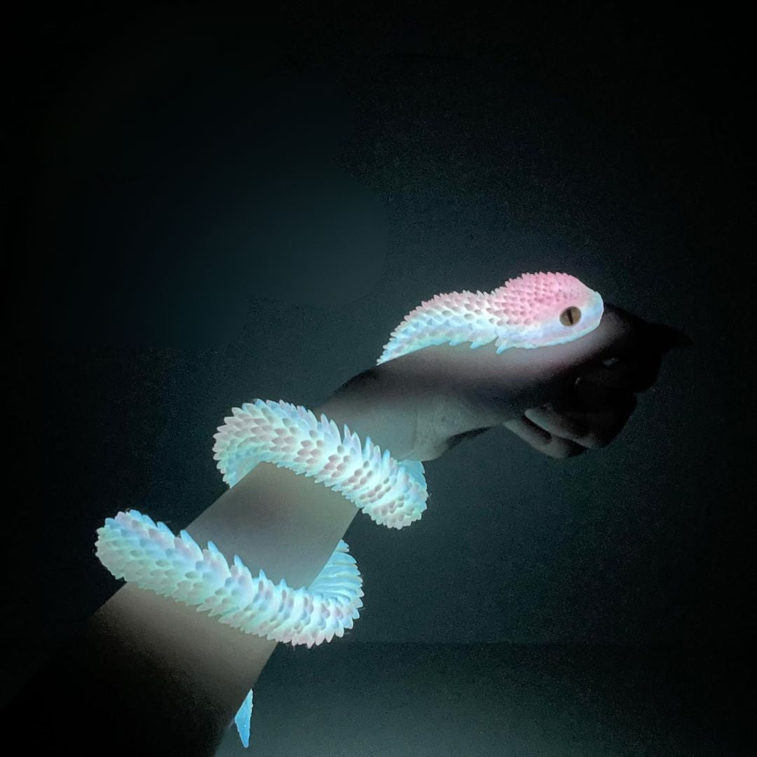 3D printed colorful LED snake fidget toy wrapped around an arm on a dark background