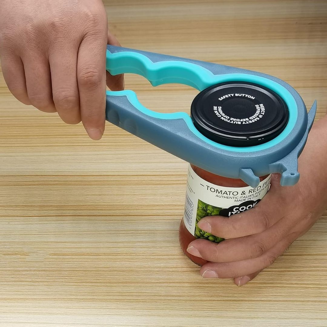 A hand opening a jar using an adjustable multi size lid opener on a wooden background
