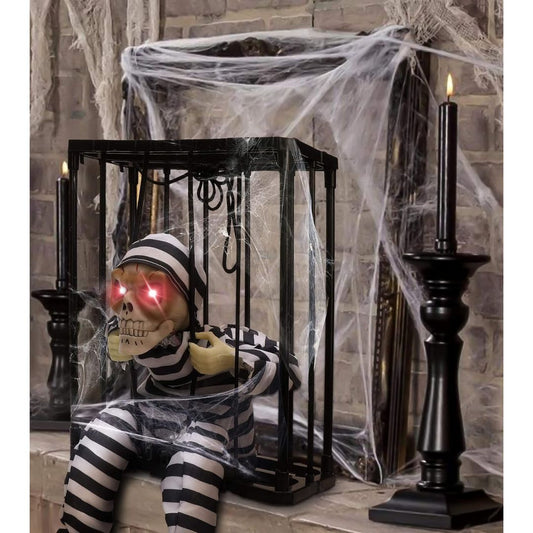 1. Spooky skeleton prisoner decoration with glowing red eyes inside a cobweb-covered cage for Halloween