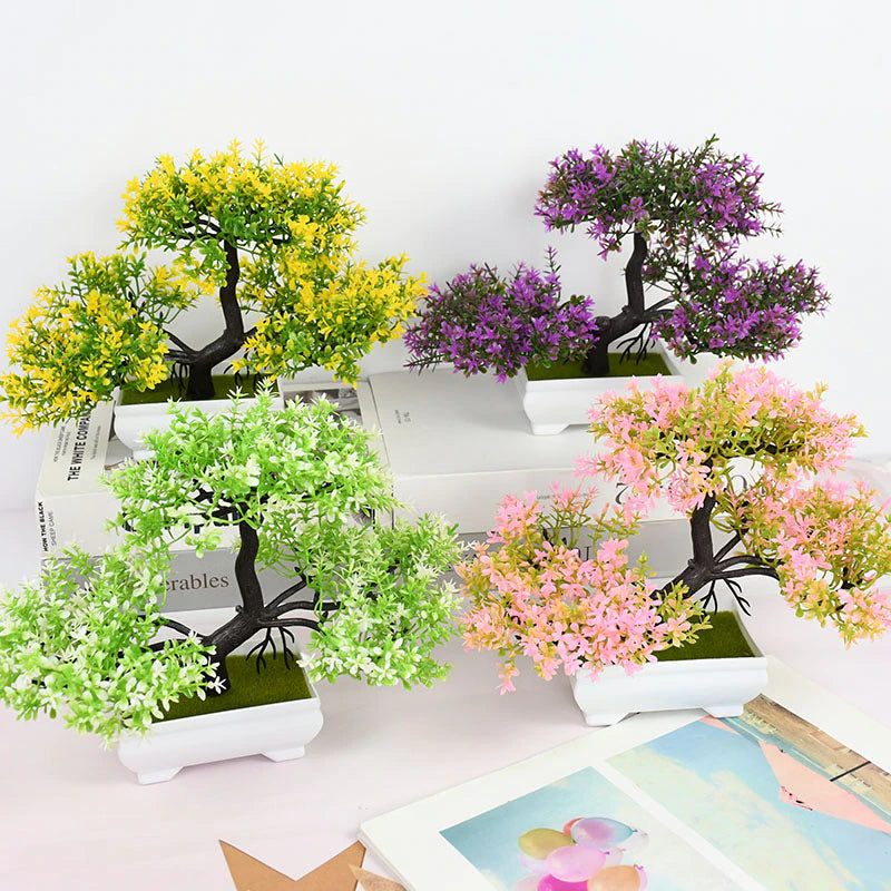 Four various colored artificial Bonsai trees.