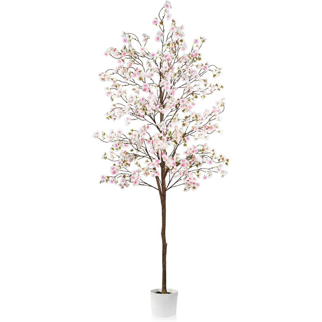 Artificial cherry blossom tree with pink flowers in a white pot on a white background